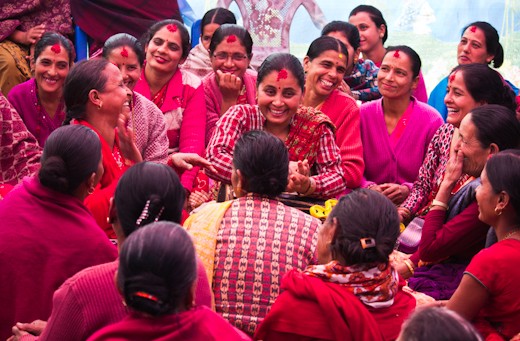 Women of all ages gather to celebrate a local marriage in Meghauli Village Nepal