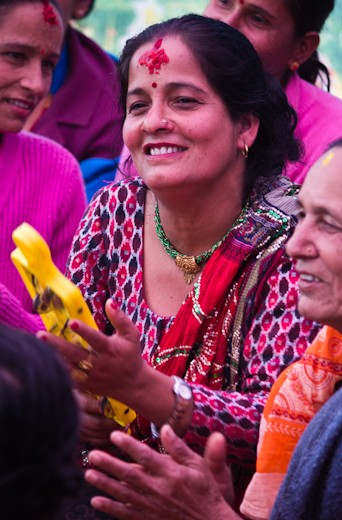 Ladies happily participate in traditional song & dance with much laughter 