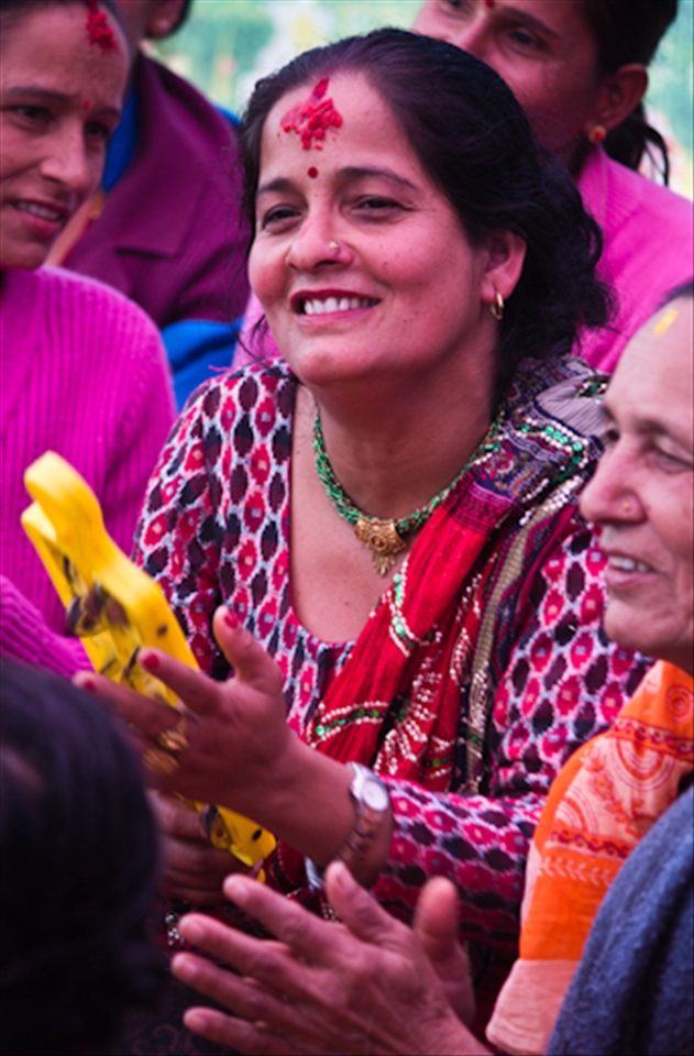 Ladies happily participate in traditional song & dance with much laughter 