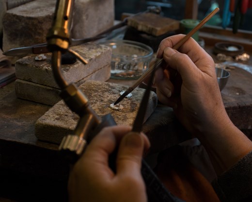 She now prepares her touch to reheat the metal so it is moldable and workable