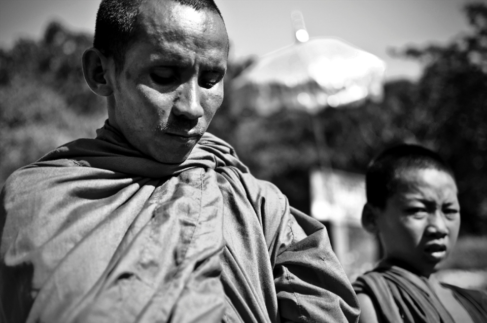 A blessing for some change. Monks stopping tourist cars for alms.