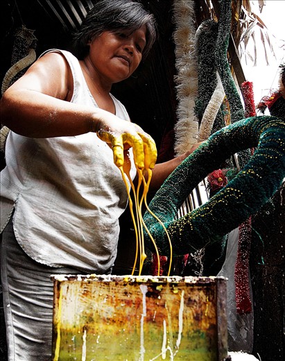 A woman decorating a lantern.