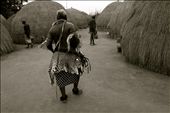 An elderly Swazi man in traditional wear wanders through a set of traditional beehive huts that house the men during the 8-week Incwala ceremony.: by alliebhughey, Views[1495]