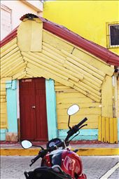 Motor bike parked along brightly colored buildings: by alofachild, Views[358]