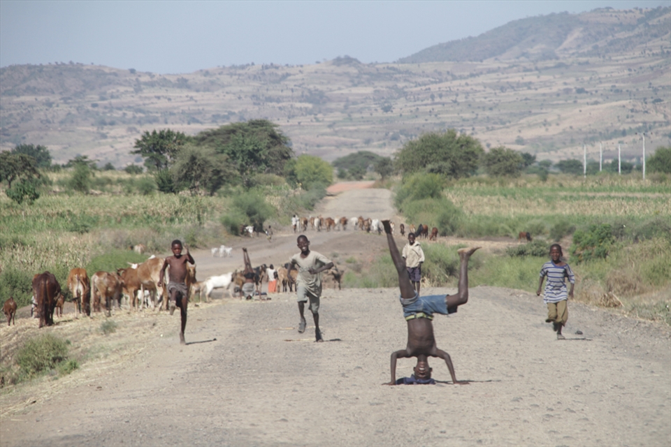 Children entertaining 'faranji' - white people randomly driving by.