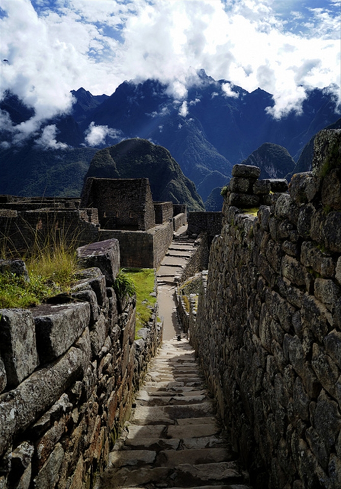 Surrounded by history:

Another shot of the citadel of Machu Picchu. This time i wanted a close  up to the textures of the ancient walls, and a leading line to compose. I did this in order to  drag the viewer eyes inside  the frame and make people see as close as my eyes saw this scene. 
Another impressive fact is  the way the ancient incas built this place. Touching the history  was another great aspect of visiting it.