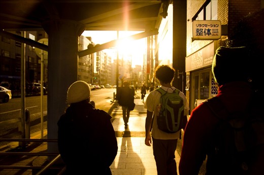 We found ourselves journeying through the city during 'golden hour'. I stood there with my camera motionless, as they walked on before me.