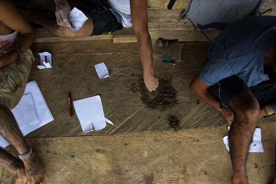 Peruvian workers relax and smoke after picking coffee