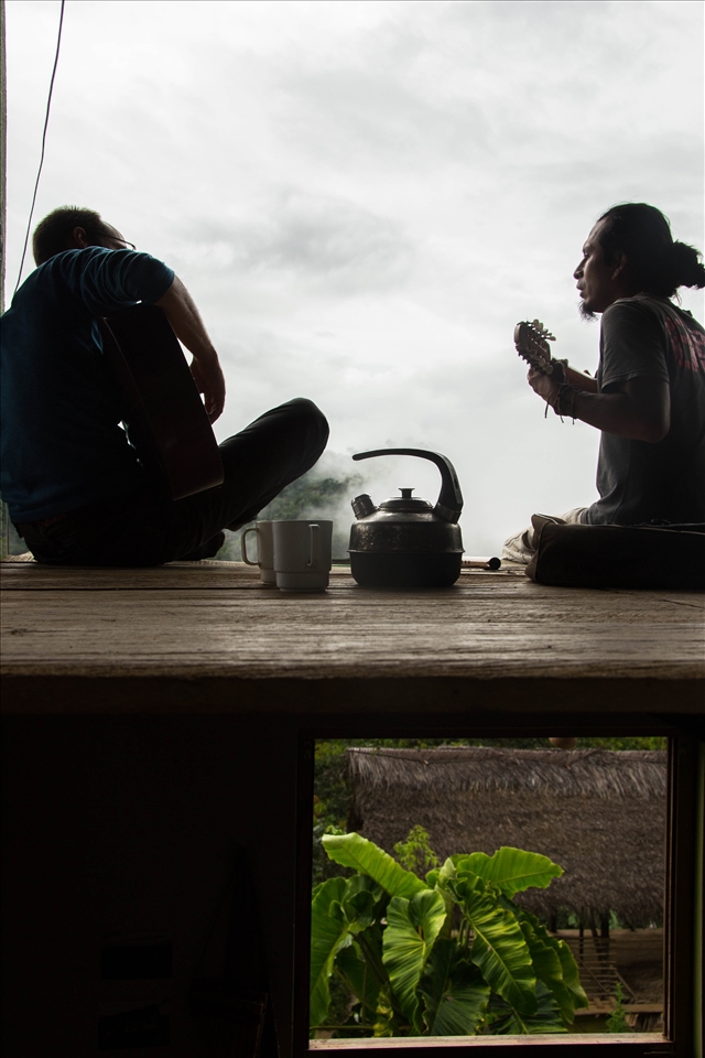 Juan Carlos, the owner of the farm, teaches a Peruvian song to a volunteer