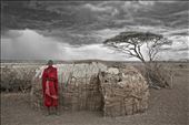 A Masai Warrior stands proud outside his home as a storm gathers over the plains: by amacphoto7, Views[300]