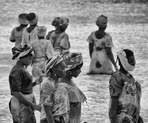 Catch of the day. These women take to the sea, fully clothed, with nets to fish.