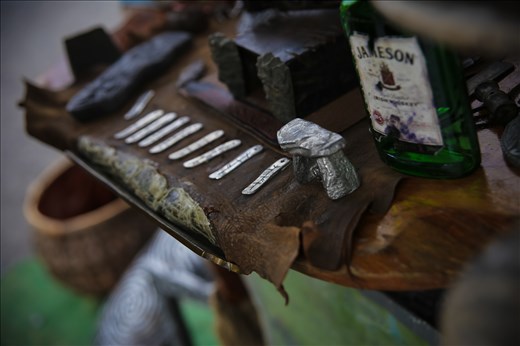 Runes are stamped into coins and pendants by artisans on the roadside.