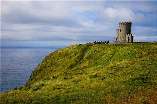 A tower dots the landscape at the Cliffs of Moher.