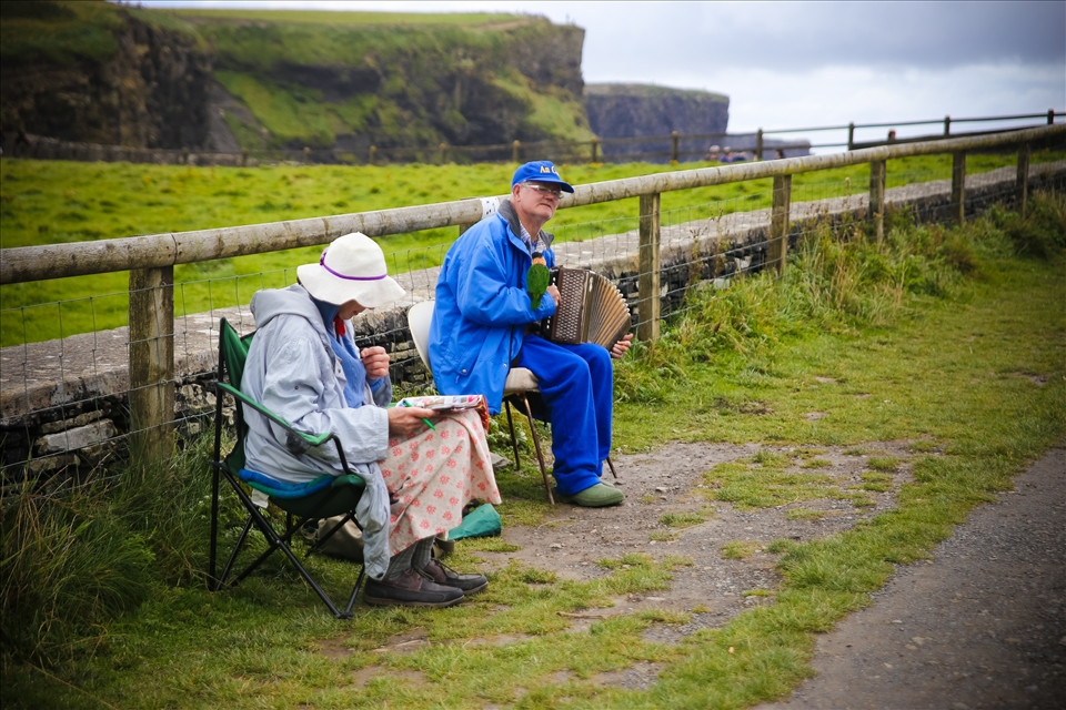 Musicians play for change near the Cliffs of Moher.