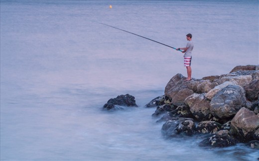 Fish is one of the main item of Malaga cusine, but this picture tells more than that. A Spanish guy with American shorts catching a fish !