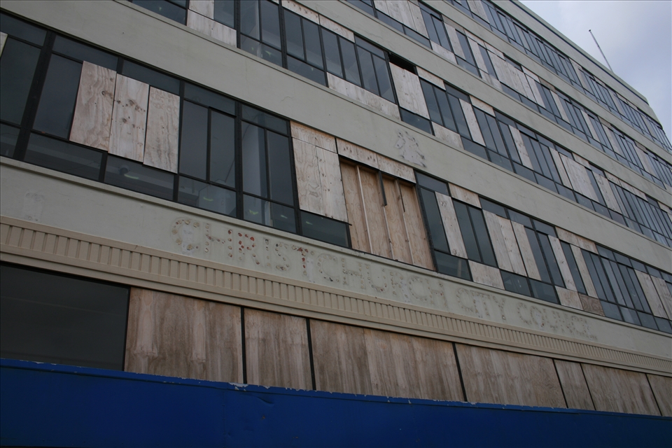 A city closed for business – 6 months after the February 2011 earthquake the Christchurch City Council offices were found to be structurally intact but missing stairways to carry workers between floors and their view blocked by the sheets of plywood replacing broken windows has left the building awaiting repair when its city needs it most.