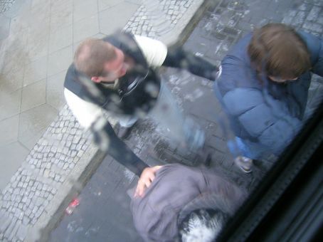 boys pushing the bus when its gliding on ice