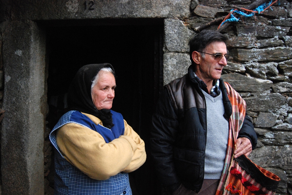Traditional House with lovely Old Lady and her Old Man watching the performance.