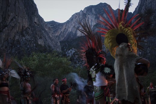 The sun is out and the ceremony is about to conclude. Some dancers play their traditional guitar covered by armadillo skin, while the flowers gathered in sticks are being passed between the assistants along with copal incense, the final blessing.