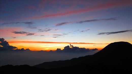 The sunset view from the peak of Mount Gede (2,958 meters). The wind had blown rather harshly this time around, yet along with it we have to walk across the trail provided to where we are going to camp and wait for the supermoon. Also shown in this photo is the peak of Mount Pangrango (3,019 meters), a sister mountain to Mount Gede. It was said that it would only take 3 hours to walk peak to peak, but we decided not to because my crews said the scenery from there is dissapointing.