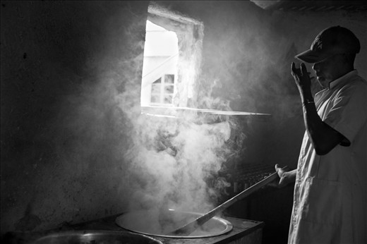 George a three year volunteer prepares porridge fo the children.
