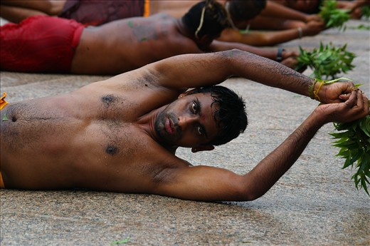  Strength of manhood is tested during rolling for Thimithi festival. Respect is given for a man rolling as long as possible.The neem leaves are to ward off evil