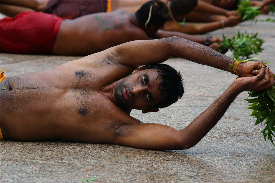  Strength of manhood is tested during rolling for Thimithi festival. Respect is given for a man rolling as long as possible.The neem leaves are to ward off evil