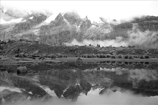 As the clouds lifted, the base of Rinrihirca began to show itself. Giving hope for a beautiful day, despite the felt presence of the rainy season. - Santa Cruz Trek, Huaraz, Peru