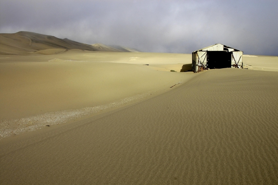 The cost of cleaning up the desert is too high so the buildings have been left to slowly rot away