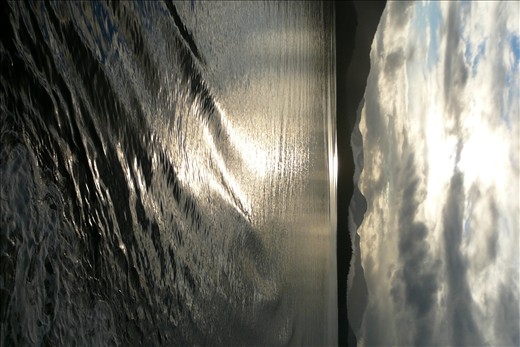 The ever changing clouds & the water beside the ship played with the sunlight.