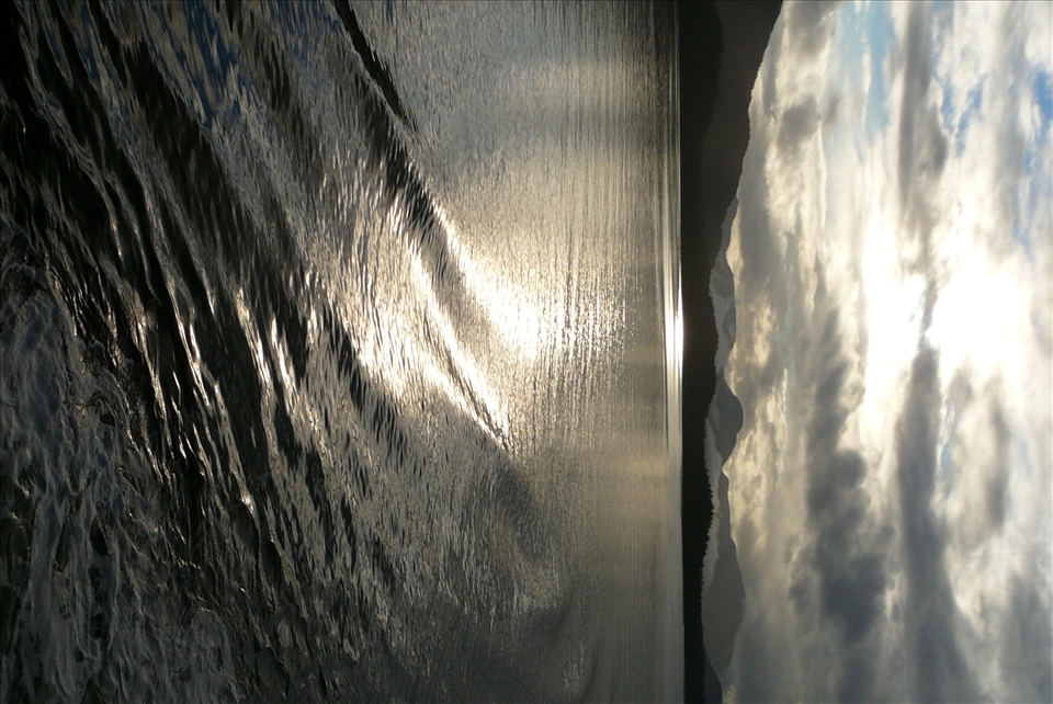 The ever changing clouds & the water beside the ship played with the sunlight.