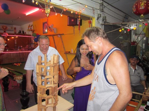 Playing a version of Jenga with a local bar owner and patrons.