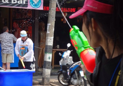 See that blue bucket?  Full of melting ice.  Buckets of ice water are set up all over the city to fill your water gun up at.  Refreshing since it is so hot here but still so col.