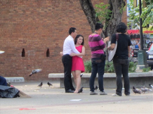 People watching at Thae Pae Gate at the moat in Chiang Mai.  What looks like engagement photos with pigeons.  