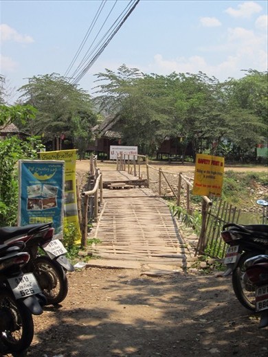The questionably constructed bamboo foot bridge leading to our bungalow.  Sophia sang a little diddy while crossing it, 