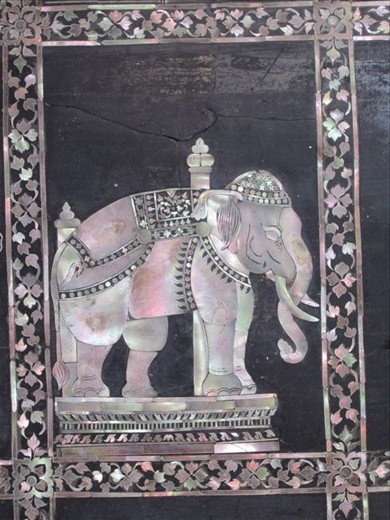 The Reclining Buddha is painted in gold, except for the bottom of the feet, which have these mother of pearl designs.  