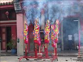 There is always something burning in the places I've visited, so I wasn't  surprised when I smelled smoke.  But then I saw these things burning in the street in front of a temple.  I asked a couple what these were for and they told me it was a goddess's birthday.  There were hundreds of candles lit inside the small temple as well.: by anealis314, Views[362]