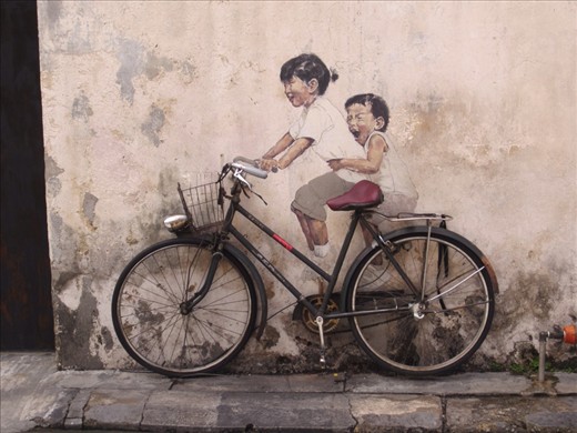 real bicycle attached to the wall.