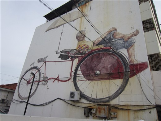 This is a mural of a local trishaw and its driver.