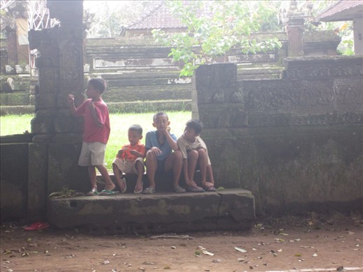Indonesian kids hanging around talking to us and playing soccer.
