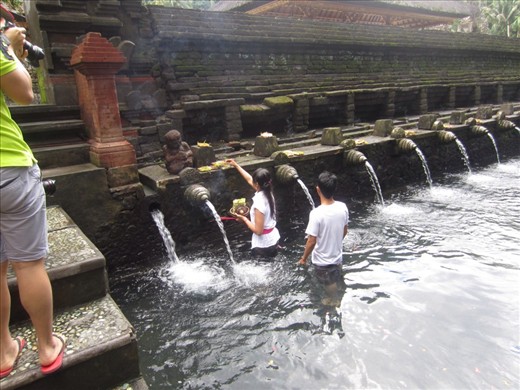 Woman making her offering at the water.
