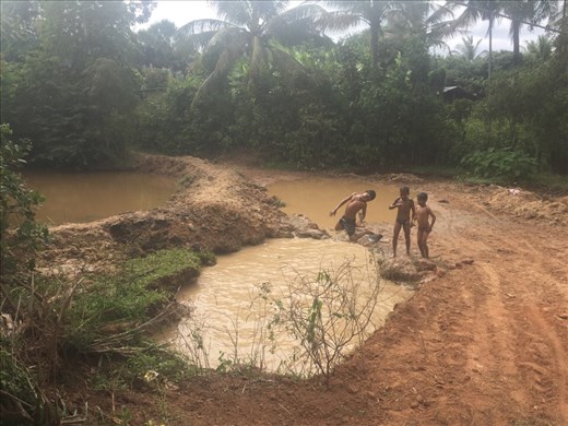 Children playing in some water pits
