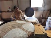 Cooking rice paper:  batter as thin as water, a hot griddle, a fire fueled by dried rice husks, and two sticks to somehow move the sheets to the drying rack: by anijensen, Views[481]
