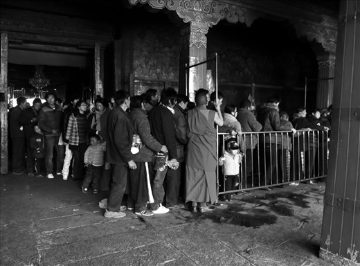 The pilgrimage:
In the life of a Buddhist a pilgrimage to a holy place or temple can be the highlight of their spiritual life. Here, pilgrims spill into Jokhang Temple, the centre of Old Town Lhasa and considered the most sacred of all temples in Tibet. Many pilgrims have travelled on foot from the outer reaches of the Tibetan territory, incredible distances which take some years. In 2013 Chinese developers began construction on a modern shopping mall, dramatically altering the area immediately surrounding Jokhang forever.