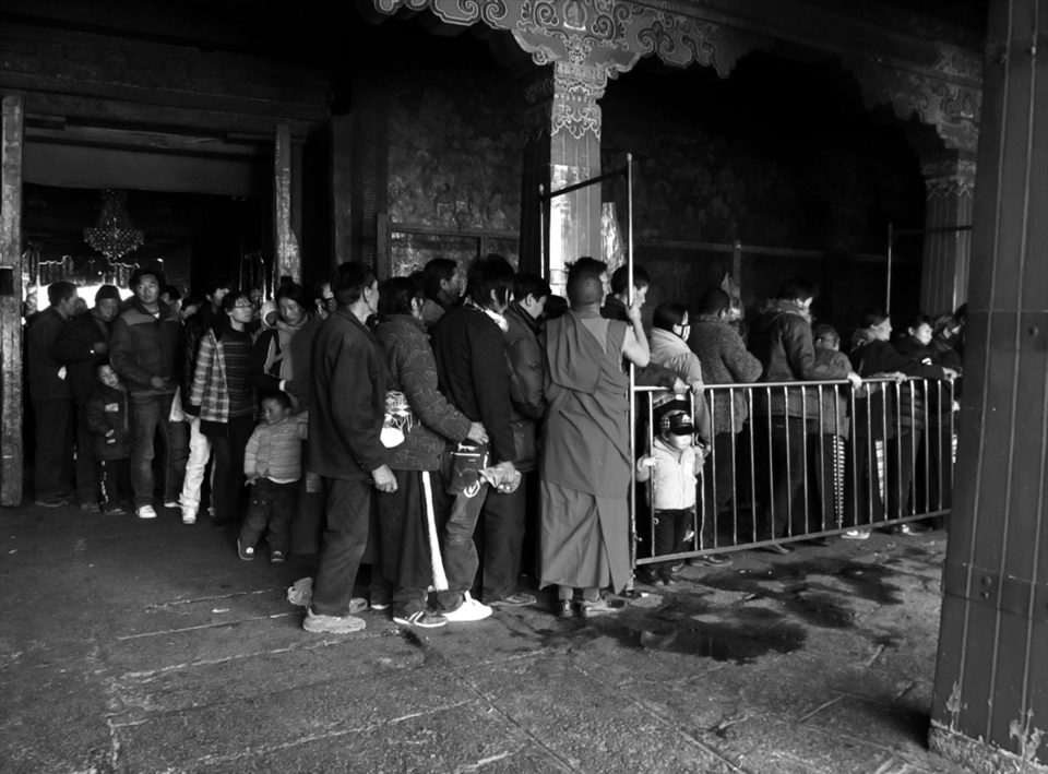 The pilgrimage:
In the life of a Buddhist a pilgrimage to a holy place or temple can be the highlight of their spiritual life. Here, pilgrims spill into Jokhang Temple, the centre of Old Town Lhasa and considered the most sacred of all temples in Tibet. Many pilgrims have travelled on foot from the outer reaches of the Tibetan territory, incredible distances which take some years. In 2013 Chinese developers began construction on a modern shopping mall, dramatically altering the area immediately surrounding Jokhang forever.