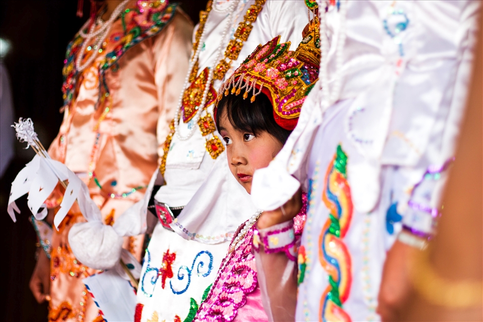 Her eyes tell the story. The awakening fear of the unknown. Her head is adorned in jewels, and the photographer before her shoots flashes at her and her towering siblings. But she cannot relax. Feverishly she bows her head and dreams of the year before, running through rice paddies and chasing after the newborn goats. Passing marbles to her friends, shouting after trekking tourists and remembering nights sat in the shadow of her mothers warmth. It would not be the same, this summer. The next day, her head would be shaved and she would enter the nunnery for several months. 