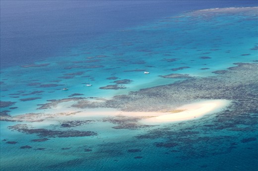 UP IN THE AIR: Boats dot Vlassof Cay in the Great Barrier Reef off the coast of Cairns in the far north of Queensland during a scenic flight over the world's largest reef system. Snorkeling in the waters of the reef and taking in the view from the air gives a holistic appreciation of this world heritage site yet creates concern amid reports that tourism is also putting pressure on the reef aside from climate change and other human activities. 