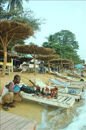 Alfa Kargbo jumps to save his crafts from waves that now reach the bars.: by annekennedy, Views[301]