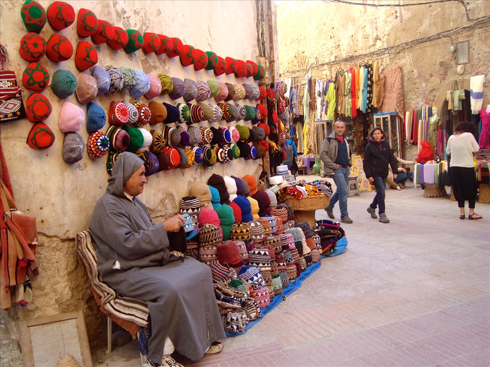 Beanies for sale. Man sells beanies in the ancient fortress in Essaouira.
