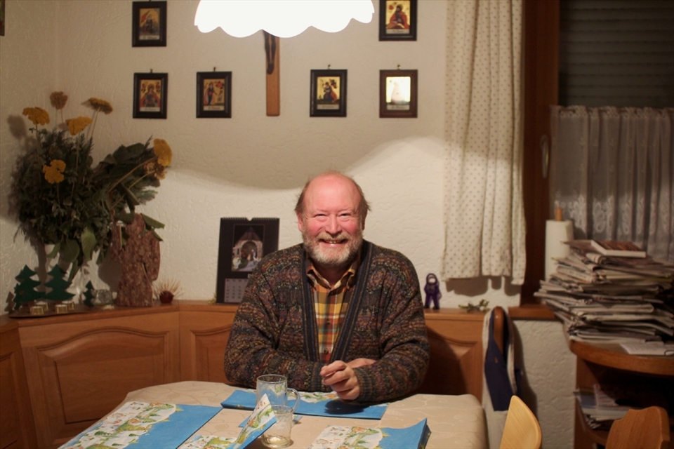 Back at home on Christmas Eve, Josef relaxes with a glass of schnapps before the midnight mass whilst his daughters decorate their tree.